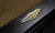 C.L. Bailey Elayna Slate Pool Table, close-up of the elegant gold emblem on the black slate surface.