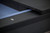Doc & Holliday Kaci Pool Table by Doc & Holliday in Black Ash, close-up of the table's corner with black wood finish and blue felt playing surface.