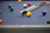 Doc & Holliday George Slate Pool Table in Marble Grey, close-up of the pool table with colorful billiard balls on the blue felt surface.