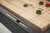 Doc & Holliday George Shuffleboard Table in Black Ash, featuring a close-up view of the playing surface with game pieces and scoring area.