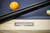 Doc & Holliday George 8' Slate Pool Table by Doc & Holliday in Natural Ash, close-up of the table's logo and pool cues on the playing surface.
