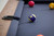 Plank & Hide Co Otis 8' Slate Pool Table in Honey Ash with blue felt and billiard balls, showing close-up of the pool table surface and cue holder.