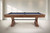 Plank & Hide Co Otis 8' Slate Pool Table in Honey Ash, free installation, in a room with white wood-paneled walls.
