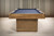 Front view of the Deco slate pool table by Plank & Hide, featuring Glazed Maple wood and golden brass accent details.