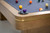 Plank & Hide Co Plank & Hide Deco 8' Slate Pool Table in Glazed Maple, close-up of the corner with detailed wood finish and pool balls on the felt surface.