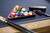 Plank & Hide Co Plank & Hide Deco 8' Slate Pool Table in Glazed Maple, featuring a sleek blue felt surface, pool cue sticks, and a triangle rack filled with colorful billiard balls.