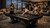 Doc & Holliday Savant 8' Slate Pool Table in Black Ash, modern pool table with sleek black finish in a stylish lounge with large windows and city skyline view.