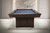 Doc & Holliday The Rook Slate Pool Table, modern pool table with dark wood finish and blue felt surface, set against a stylish marble and paneled wall background.