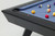 Doc & Holliday The Bellano Slate Pool Table in Matte Black, close-up of the corner showing the sleek matte black finish, blue felt surface, and pool balls in play.