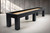 Doc & Holliday Peter Parsons Shuffleboard Table Matte Black Laquer, modern shuffleboard table with matte black finish and wooden playing surface in a minimalistic room.