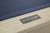 Close-up of the steel Doc & Holliday logo plate on the Savant pool table