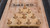 Plank & Hide Co Plank & Hide Shuffleboard Bowling Pin Set, wooden shuffleboard game with ten wooden pins arranged on a shuffleboard court.