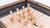 Plank & Hide Co Plank & Hide Shuffleboard Bowling Pin Set, wooden game pieces on shuffleboard table with scoring area and wooden border.
