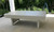 Sawyer Twain Matrix Outdoor Slate Pool Table with Sunbrella Felt, made in USA, on an outdoor patio with greenery in the background.