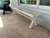 Sawyer Twain X-Air 8' Outdoor Slate Pool Table | Sawyer Twain, white outdoor slate pool table placed on patio next to a window and outdoor chair.