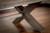 Billiards Select Huxley 8' Slate Pool Table, close-up view of the wooden structure with a dark brown finish and X-shaped legs on a wooden floor, highlighting the craftsmanship and design for premium gameplay.