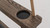 Plank & Hide Co Spectator Chair, close-up view of wooden armrest with built-in circular black rubber cup holder.
