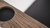 Plank & Hide Co Spectator Chair, close-up of the wooden armrest with a circular black speaker embedded.
