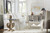 Hooker Furniture Boheme Flanders Square Cocktail Table, gray distressed wooden table with decorative cut-outs in a cozy white living room with a sofa, armchair, and decorative accents.