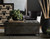 Hooker Furniture Leesburg Chairside Chest, dark wooden chest with geometric carved pattern on the front, placed in a modern living room setting.