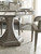 Hooker Furniture Sanctuary Rectangle Dining Table with 2-20 inch leaves, shown in a light wood finish, with dining chairs and elegant glassware set for a stylish dining room.
