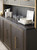 Hooker Furniture Curata Buffet/Credenza, dark wood finish with gold trim and handles, featuring storage cabinets and display space.