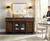 Hooker Furniture Leesburg Buffet, a traditional wooden sideboard with glass-paneled doors, decorative columns, and a polished dark finish, topped with a fruit display and serving ware in a dining room setting.