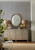 Hooker Furniture Elixir Buffet, elegant sideboard with a sunburst pattern, topped with gold and beige table lamps, vases, and decorative bowls, reflecting a sophisticated interior design style