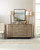 Hooker Furniture Affinity Server, modern wooden sideboard with silver handles, decorated with lamps, plants, and decorative pieces in a well-lit room.
