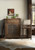 Hooker Furniture Comfort Counter Stool, a traditional style counter stool with a wooden frame and cushioned beige seat and backrest, positioned next to a vintage wooden cabinet in a cozy living space.