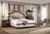 Hooker Furniture Leesburg Queen Upholstered Bed, elegant bedroom with tufted beige headboard, wooden nightstands, decorative pillows, and classic decor.