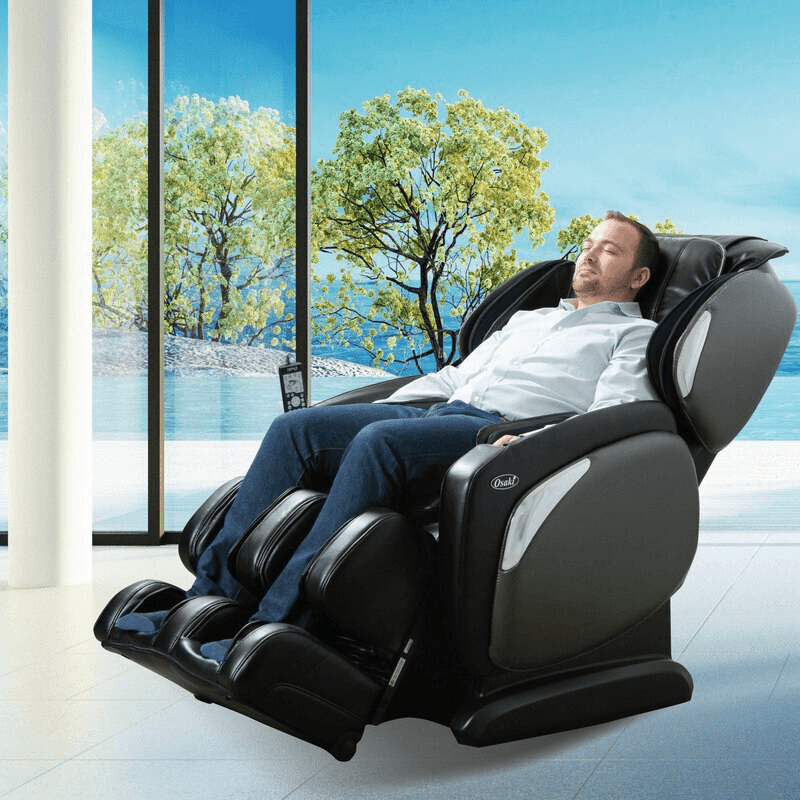 man sitting in black massage chair