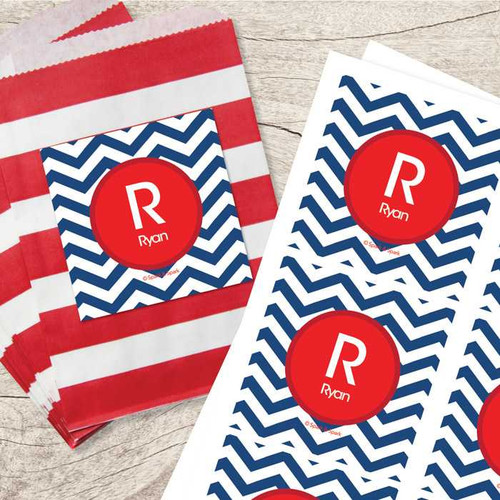 SparkGreetings® Chevron Navy & Red Gift Label Set, personalized gift labels with a red circular monogram featuring the letter 'R' and the name 'Ryan' on blue and white chevron patterned background.