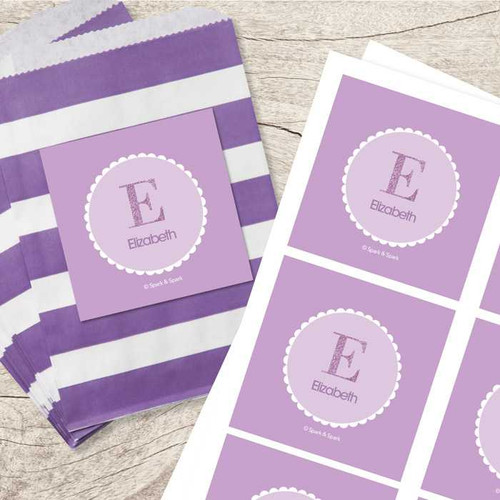 SparkGreetings® A Shiny Letter Purple Gift Label Set, set of personalized purple gift labels with names and initials on white-bordered circular backgrounds.