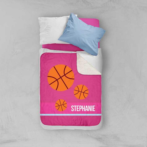 Spark & Spark Girl Basketball Fan Pink Sherpa Blanket, personalized with the name Stephanie and featuring basketball graphics on a bed with pillows.