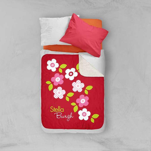 Spark & Spark Preppy Flowers Red Sherpa Blanket, vibrant red blanket with pink and white floral design and personalized name Stella Burgh, on bed with white pillow and pink pillow.