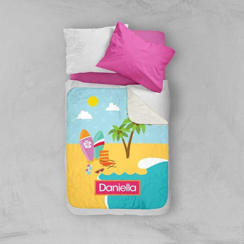 Spark & Spark Fun At The Beach Sherpa Blanket with personalized name Daniella, featuring a colorful beach scene with surfboards, palm trees, and sunny sky on a bed with pink and white pillows.