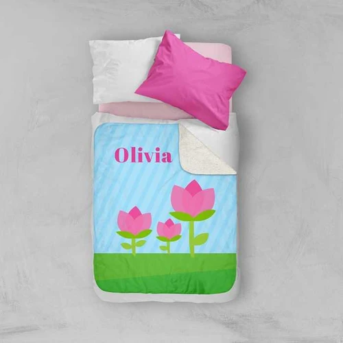 Spark & Spark Cute Tulip Sherpa Blanket, personalized blanket featuring pink tulip flowers and the name Olivia on a light blue background with green grass.
