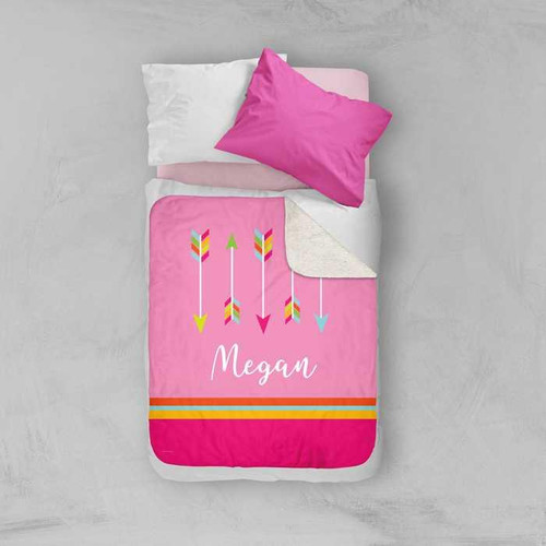 Spark & Spark Colorful Arrows Sherpa Blanket with personalized name Megan on pink background, displayed on bed with white and pink pillows.