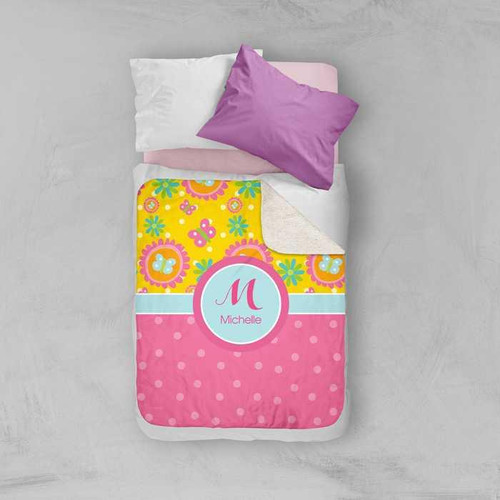 Spark & Spark Yellow Flowers Pattern Sherpa Blanket, colorful floral and polka dot design with a personalized name monogram on a bed.