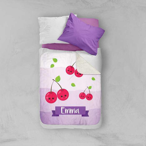 Spark & Spark Yummy Cherries Sherpa Blanket, pink and white blanket with cherry illustrations and personalized name Emma at the bottom.