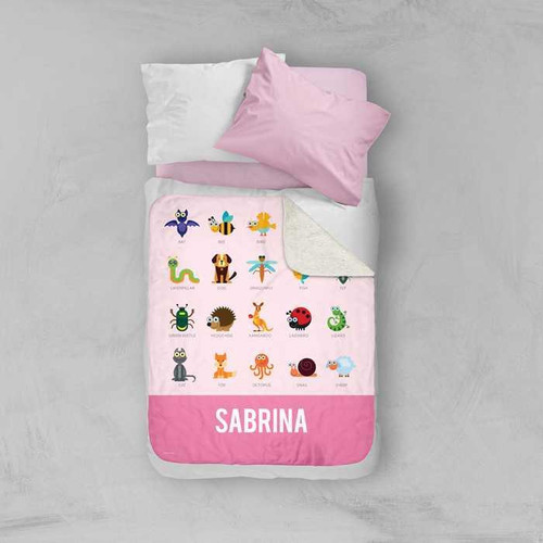 Spark & Spark Sweet Animal Chart Pink Sherpa Blanket, pink children's blanket with colorful cartoon animals and the name Sabrina printed at the bottom.