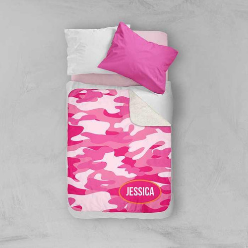 Spark & Spark Pink & Orange Camouflage Sherpa Blanket, personalized with the name Jessica, on a bed with pink and white pillows.