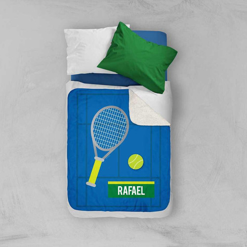 Spark & Spark Tennis Fan Sherpa Blanket, blue blanket with tennis racket, tennis ball, and personalized name Rafael on it, laying on a bed with pillows.
