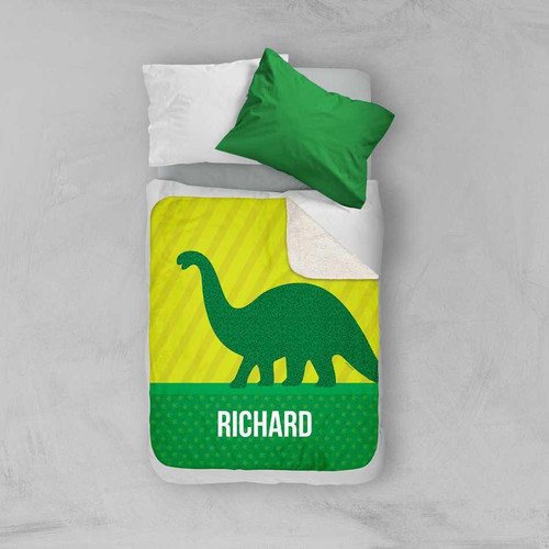 Spark & Spark Dino and Me - Green Sherpa Blanket, colorful dinosaur themed blanket with personalized name Richard, on a bed with white and green pillows.
