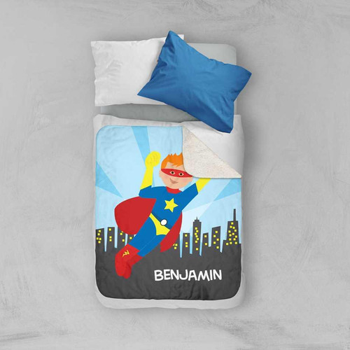 Spark & Spark A Cool Superhero Sherpa Blanket, colorful children's superhero blanket with a cartoon superhero character flying over city buildings and the name Benjamin at the bottom.