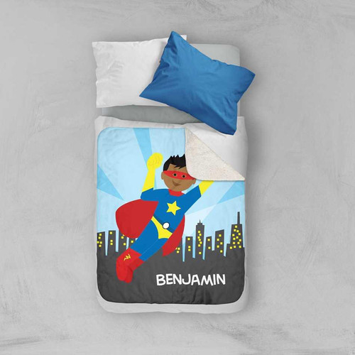 Spark & Spark A Cool Superhero Sherpa Blanket, featuring a colorful cartoon superhero with a red cape and mask flying over a city skyline with the name Benjamin at the bottom.