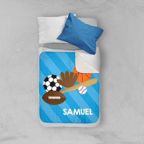 Spark & Spark Sports Fan Sherpa Blanket, personalized children's bed blanket with sports-themed design including a soccer ball, basketball, baseball, football, and a baseball bat, with the name Samuel printed on it.