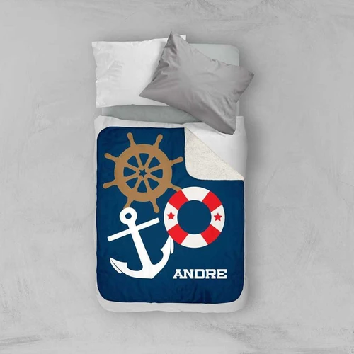 Spark & Spark Nautical Ways Sherpa Blanket, navy blue blanket with nautical designs including a ship's wheel, an anchor, and a life preserver, with the name 'André' printed on it.