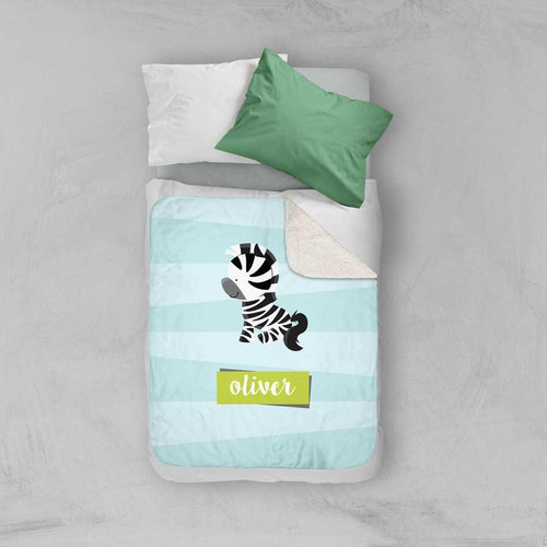 Spark & Spark Cute Baby Zebra Sherpa Blanket, soft baby blanket with a zebra design and customizable name 'Oliver' on a child's bed.